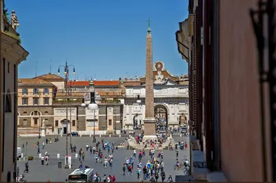 a group of people walking around a plaza in a city at Tridente Suites in Rome