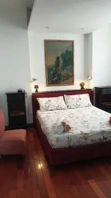 a dog laying on a bed in a bedroom at 2MG: appartamento con terrazzo nel cuore di Roma! in Rome