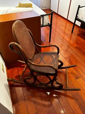 a rocking chair sitting on top of a wooden floor at 2MG: appartamento con terrazzo nel cuore di Roma! in Rome
