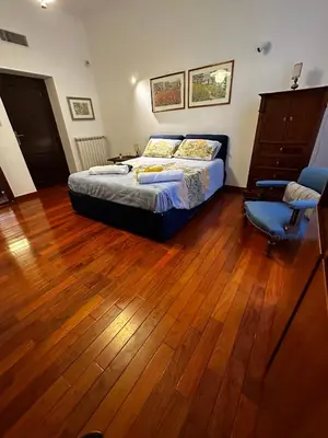 a bedroom with a bed and a wooden floor at 2MG: appartamento con terrazzo nel cuore di Roma! in Rome