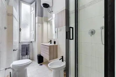 a bathroom with a toilet and a sink and a shower at Colors & Culture near Colosseum in Rome