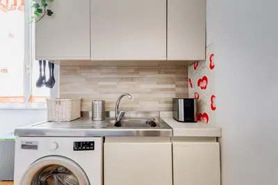 a kitchen with a sink and a washing machine at Colors & Culture near Colosseum in Rome
