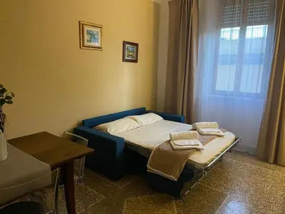 a small room with a bed and a window at Brando Apartment in Rome