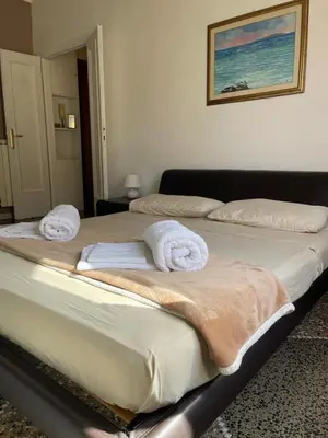 two beds in a room with towels on them at Brando Apartment in Rome