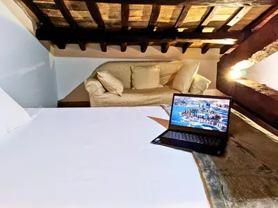 a laptop on a table in a room with a couch at Smart Lodging Prime in Rome