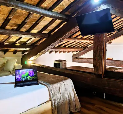 a bedroom with a bed with a laptop on a table at Smart Lodging Prime in Rome
