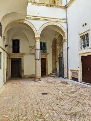 an empty courtyard of a building with two entrances at Smart Lodging Prime in Rome