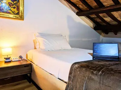 a bedroom with a bed with a laptop on it at Smart Lodging Prime in Rome