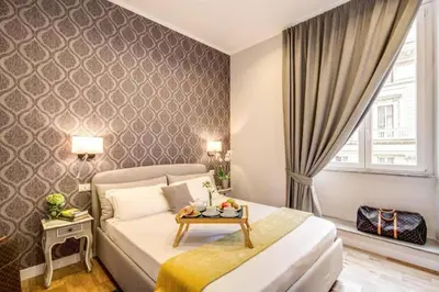 a bedroom with a bed with a table on it at TLV Navona in Rome