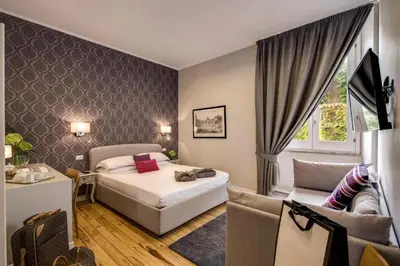 a hotel room with a bed and a couch at TLV Navona in Rome