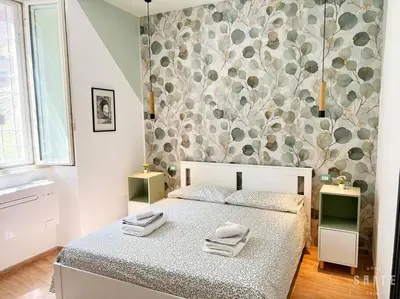 a bedroom with a bed with towels on it at Roma Suite Epiro in Rome