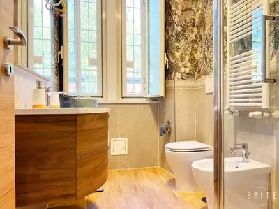 a bathroom with a toilet and a sink at Roma Suite Epiro in Rome