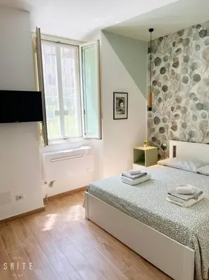 a bedroom with a bed with towels on it at Roma Suite Epiro in Rome