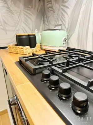 a stove top with a toaster on top of it at Roma Suite Epiro in Rome
