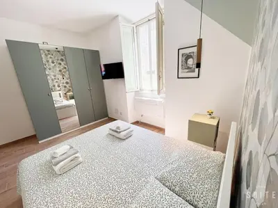 a bedroom with a large bed with two towels on it at Roma Suite Epiro in Rome