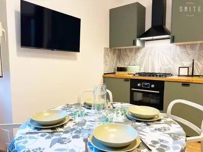 a kitchen with a table with plates on it at Roma Suite Epiro in Rome