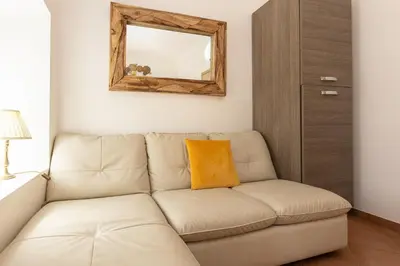 a living room with a couch and a mirror at Turati by Rental in Rome in Rome