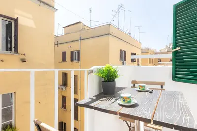 a balcony with a table with a plate of food on it at Turati by Rental in Rome in Rome