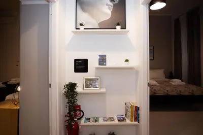 a room with a white wall with shelves at Persia Collection Colosseo in Rome