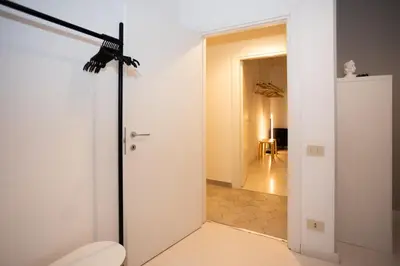 a bathroom with a toilet and a room with a hallway at Persia Collection Colosseo in Rome