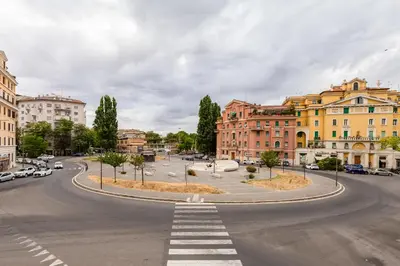 an empty street in a city with buildings at BMGA l Elegant Four-Room Apt for 8 Guests in Prati in Rome