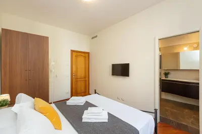 a bedroom with a white bed and a tv at Vatican Museum by Rental in Rome in Rome