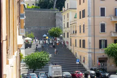 a bunch of stairs in a city with cars at Vatican Museum by Rental in Rome in Rome