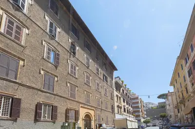 a large brick building with windows on a street at Vatican Museum by Rental in Rome in Rome