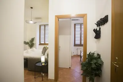 a hallway with a room with a bed and a table at Monti Colosseum in Rome