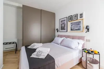 a bedroom with a bed and a table with towels on it at Luxury Trastevere gym & rooftop 5H in Rome