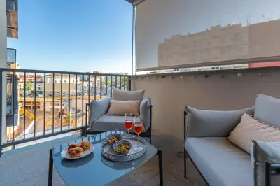a balcony with two couches and a table with glasses of wine at Luxury Trastevere gym & rooftop 5H in Rome