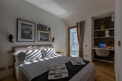 a bedroom with a bed with two towels on it at Luxury Trastevere gym & rooftop 5H in Rome
