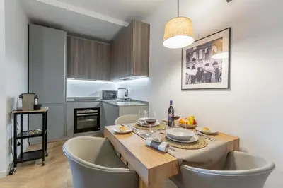 a kitchen and dining room with a table and chairs at Luxury Trastevere gym & rooftop 5H in Rome