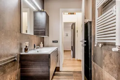 a kitchen with a sink and a hallway at BBHOME Elegant apartment at Saint Peter front of Vatican in Rome