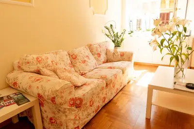 a living room with a couch and a table at Borghese Magnolia Suite in Rome