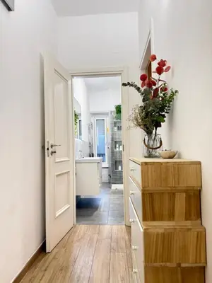 a kitchen with a door leading to a bathroom with a tub at Cozy flat with terrace at Trastevere train station in Rome