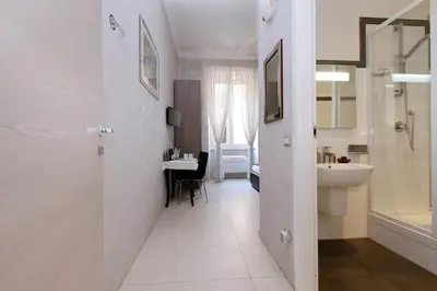 a white bathroom with a sink and a toilet and a sink at Domus Gallo Guest House in Rome
