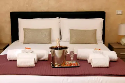 a bed with a tray of food on top of it at Domus Gallo Guest House in Rome