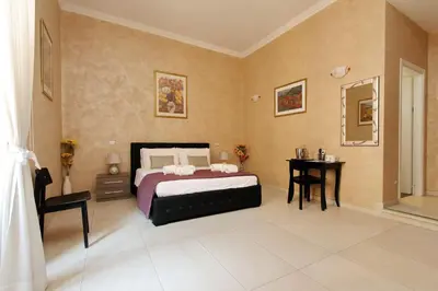 a bedroom with a bed and a table in it at Domus Gallo Guest House in Rome