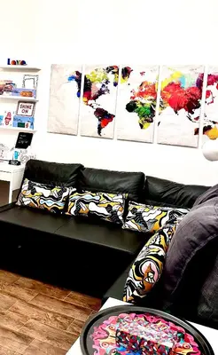 a black couch with colorful pillows in a living room at Trastevere Gianicolense casa con giardino in Rome