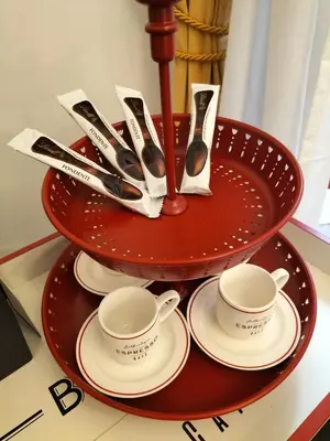 a red tray with cups and saucers and spoons at Trastevere Gianicolense casa con giardino in Rome