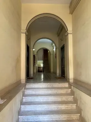 an empty hallway with stairs in an old building at Laura Apartment in Rome