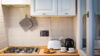 a kitchen counter with a stove and a tea kettle at Atheneum by Rental in Rome in Rome