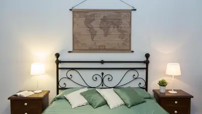 a bedroom with a bed with a map on the wall at Atheneum by Rental in Rome in Rome