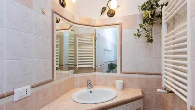 a bathroom with a sink and a mirror at Atheneum by Rental in Rome in Rome