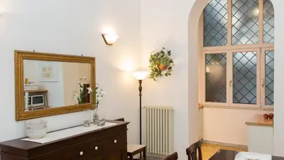 a living room with a mirror and a dresser at Atheneum by Rental in Rome in Rome