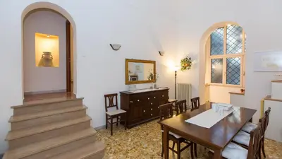 a dining room with a table and a mirror at Atheneum by Rental in Rome in Rome