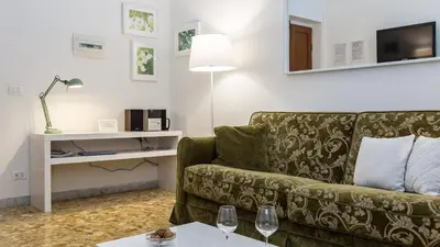 a living room with a couch and a table at Atheneum by Rental in Rome in Rome