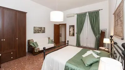 a bedroom with a bed and a chair at Atheneum by Rental in Rome in Rome