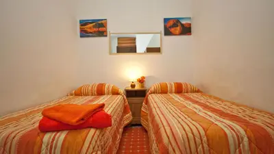 two twin beds in a room with at Rental in Rome Celeste Apartment in Rome